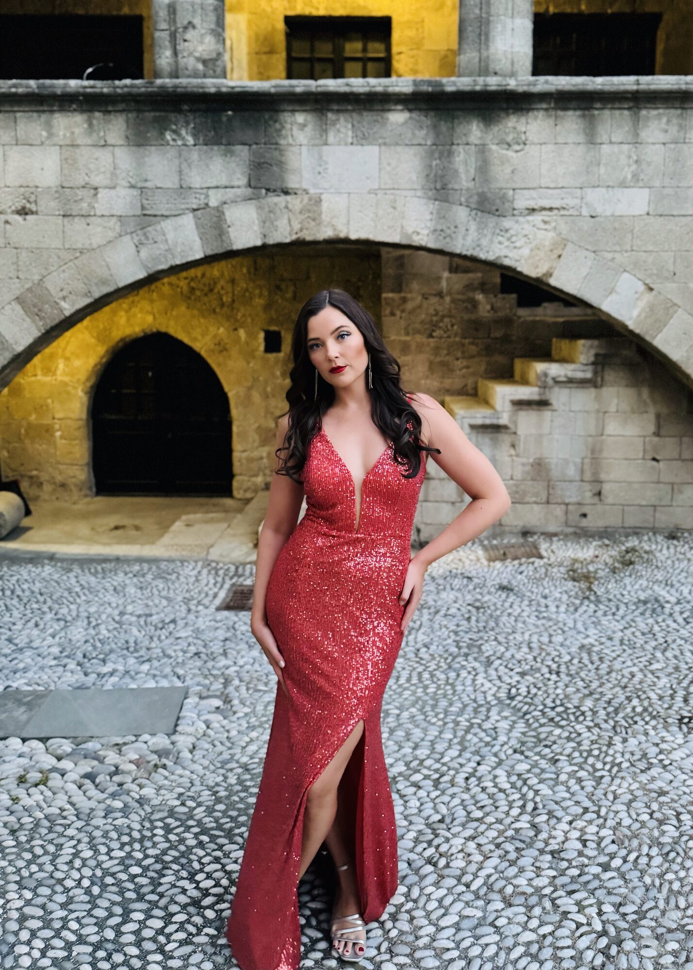 Lana Domeney in red gown, archway